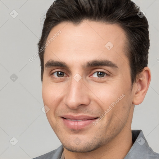 Joyful white young-adult male with short  brown hair and brown eyes