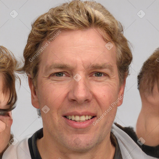 Joyful white adult male with medium  brown hair and brown eyes