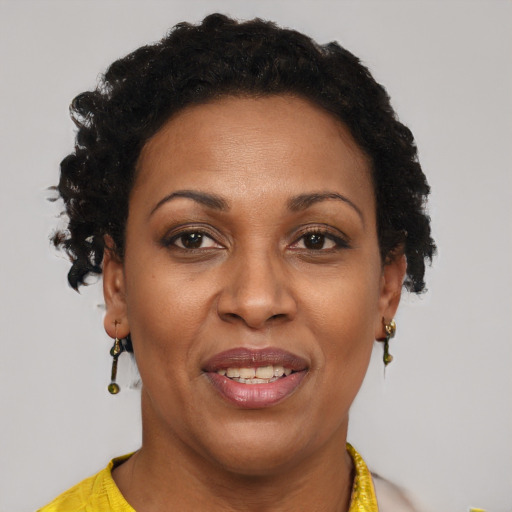 Joyful black adult female with short  brown hair and brown eyes