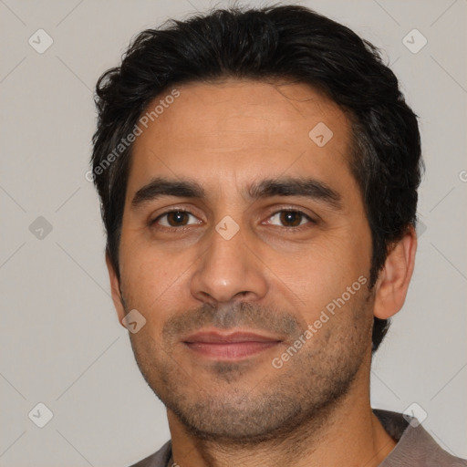 Joyful white young-adult male with short  black hair and brown eyes