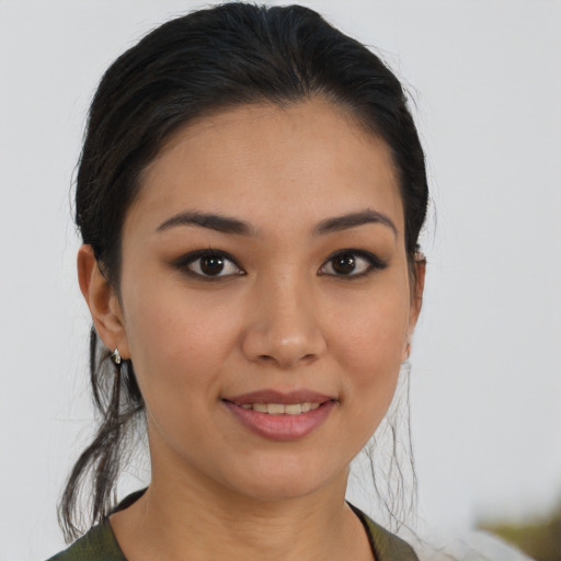 Joyful asian young-adult female with medium  brown hair and brown eyes