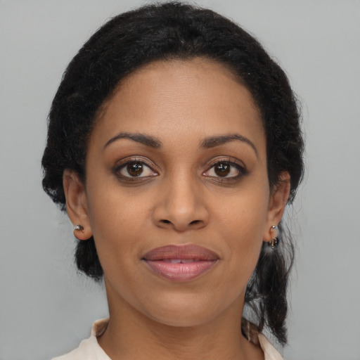 Joyful black young-adult female with medium  brown hair and brown eyes
