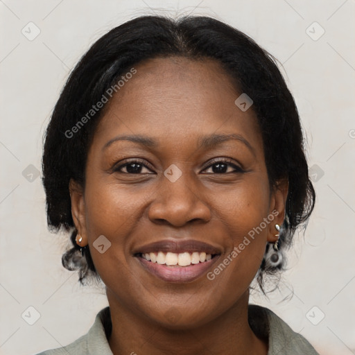 Joyful black young-adult female with medium  brown hair and brown eyes