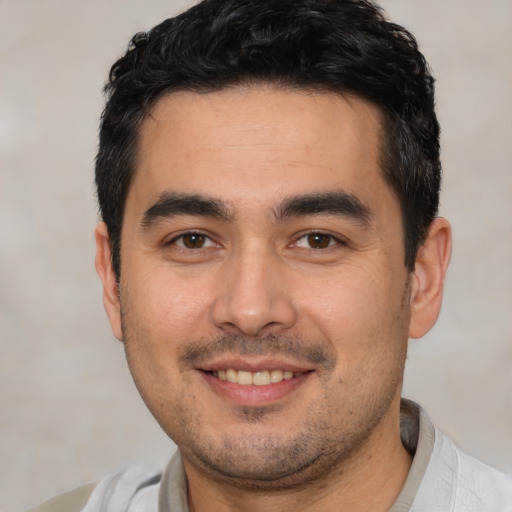 Joyful white young-adult male with short  black hair and brown eyes