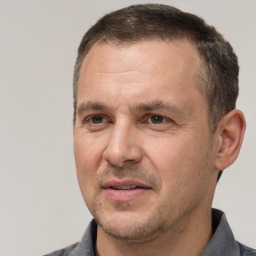 Joyful white adult male with short  brown hair and brown eyes