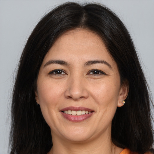 Joyful white adult female with long  brown hair and brown eyes