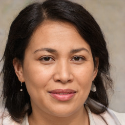 Joyful white adult female with medium  brown hair and brown eyes