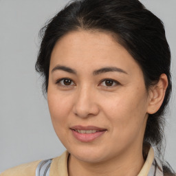 Joyful white adult female with medium  brown hair and brown eyes