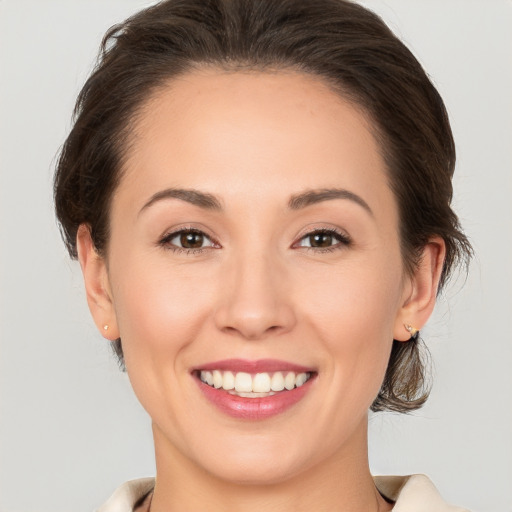 Joyful white young-adult female with medium  brown hair and brown eyes