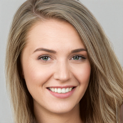 Joyful white young-adult female with long  brown hair and grey eyes