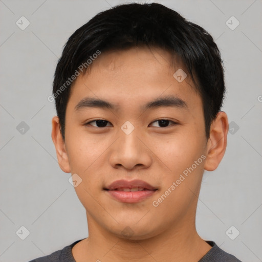 Joyful asian young-adult male with short  brown hair and brown eyes