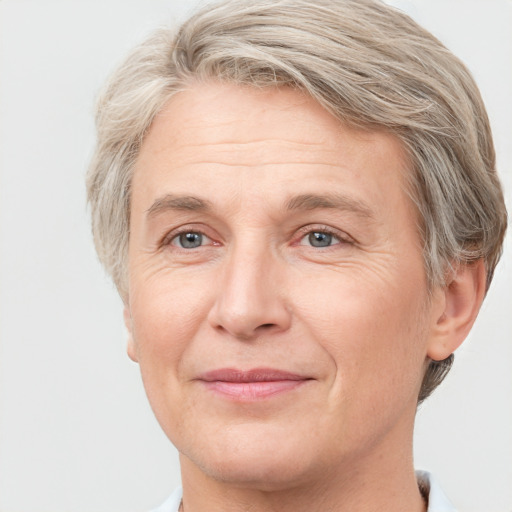 Joyful white adult female with short  brown hair and grey eyes