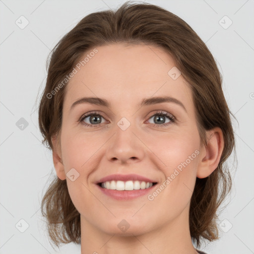 Joyful white young-adult female with medium  brown hair and grey eyes