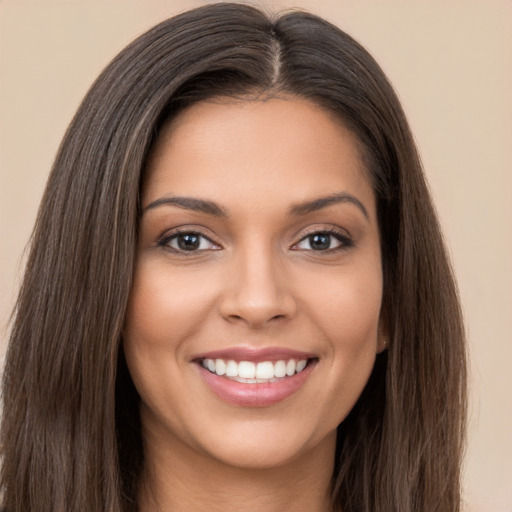 Joyful white young-adult female with long  brown hair and brown eyes