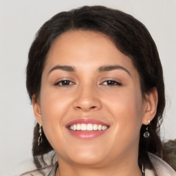 Joyful latino young-adult female with long  brown hair and brown eyes