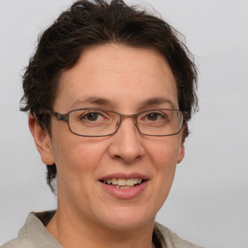 Joyful white adult female with short  brown hair and grey eyes