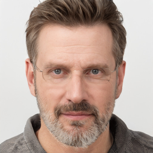 Joyful white adult male with short  brown hair and grey eyes