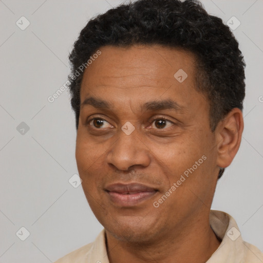 Joyful black adult male with short  black hair and brown eyes