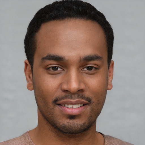 Joyful latino young-adult male with short  brown hair and brown eyes