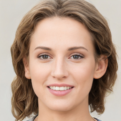 Joyful white young-adult female with medium  brown hair and green eyes