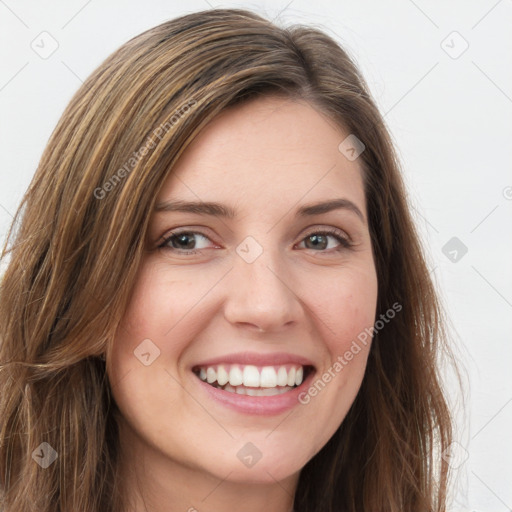 Joyful white young-adult female with long  brown hair and green eyes