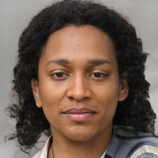 Joyful black young-adult female with medium  brown hair and brown eyes