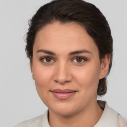 Joyful white young-adult female with medium  brown hair and brown eyes