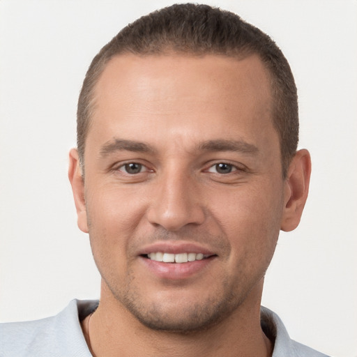 Joyful white young-adult male with short  brown hair and brown eyes