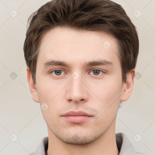 Neutral white young-adult male with short  brown hair and grey eyes