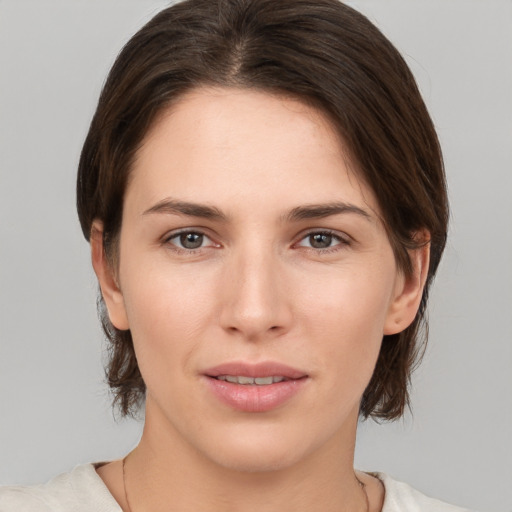 Joyful white young-adult female with medium  brown hair and brown eyes