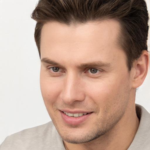 Joyful white young-adult male with short  brown hair and brown eyes