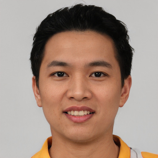 Joyful asian young-adult male with short  black hair and brown eyes