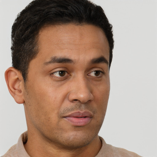 Neutral latino young-adult male with short  brown hair and brown eyes