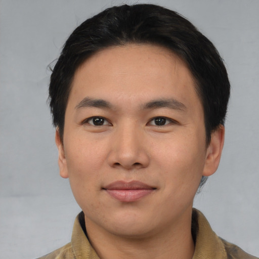 Joyful asian young-adult male with short  black hair and brown eyes