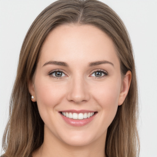 Joyful white young-adult female with long  brown hair and grey eyes