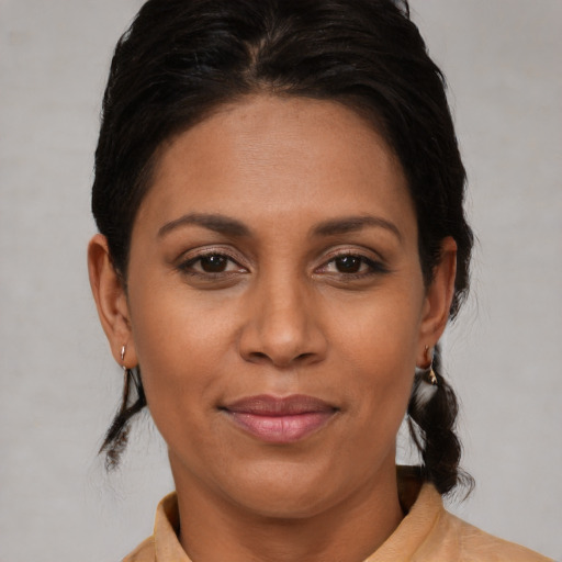 Joyful black young-adult female with medium  brown hair and brown eyes