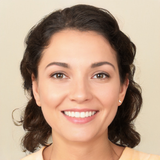 Joyful white young-adult female with medium  brown hair and brown eyes