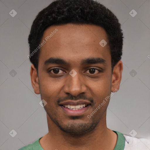 Joyful black young-adult male with short  black hair and brown eyes
