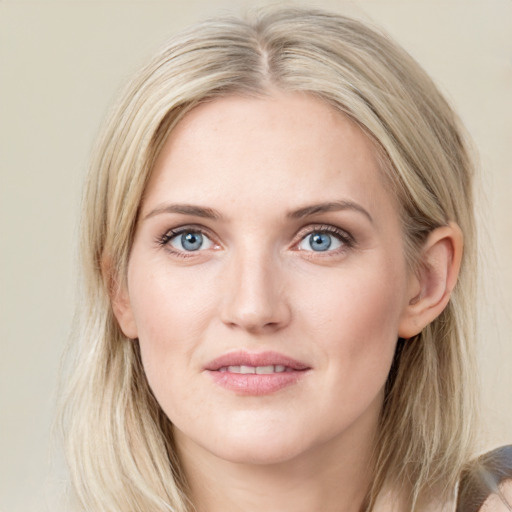 Joyful white young-adult female with medium  brown hair and blue eyes