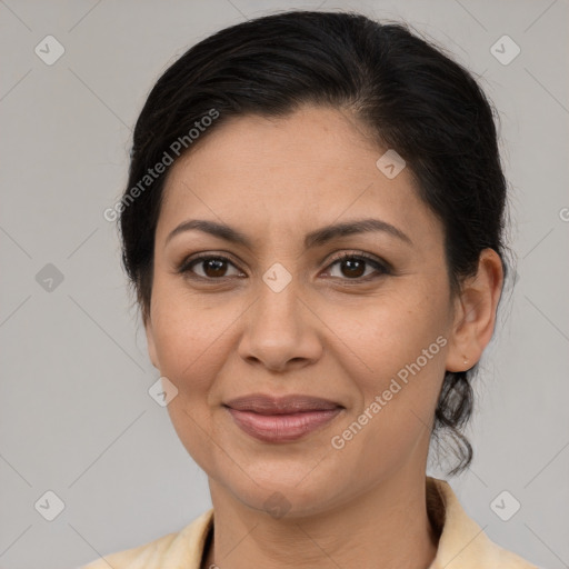 Joyful latino adult female with medium  brown hair and brown eyes