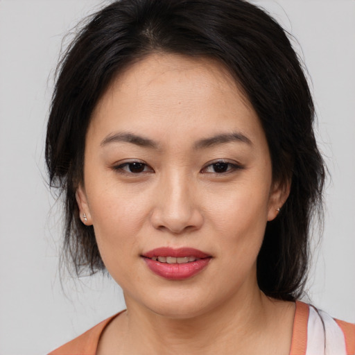 Joyful asian young-adult female with medium  brown hair and brown eyes