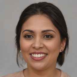 Joyful white young-adult female with medium  brown hair and brown eyes