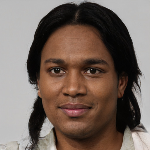 Joyful black young-adult male with medium  black hair and brown eyes