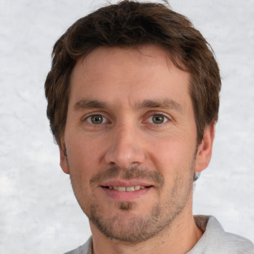 Joyful white adult male with short  brown hair and brown eyes