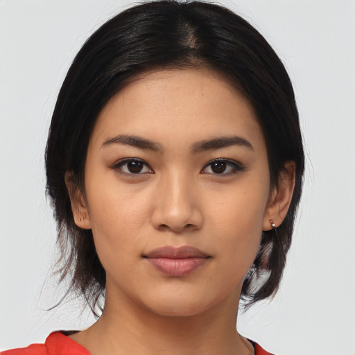 Joyful asian young-adult female with medium  black hair and brown eyes