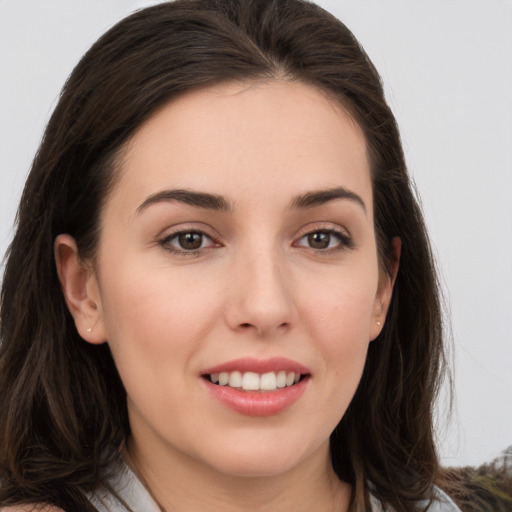 Joyful white young-adult female with long  brown hair and grey eyes