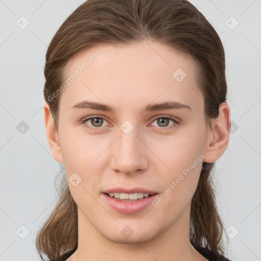 Joyful white young-adult female with long  brown hair and grey eyes