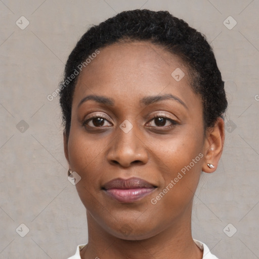 Joyful black young-adult female with short  brown hair and brown eyes