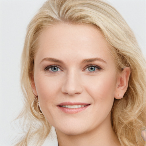 Joyful white young-adult female with long  brown hair and blue eyes