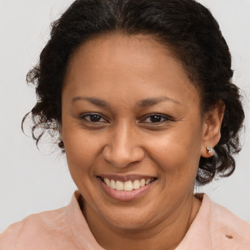 Joyful black adult female with medium  brown hair and brown eyes